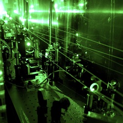 Laser spectroscopy to see the proton size. A complex laser system is needed to perform the muonic hydrogen experiment. The picture shows frequency doubling optics transforming infrared to green light.